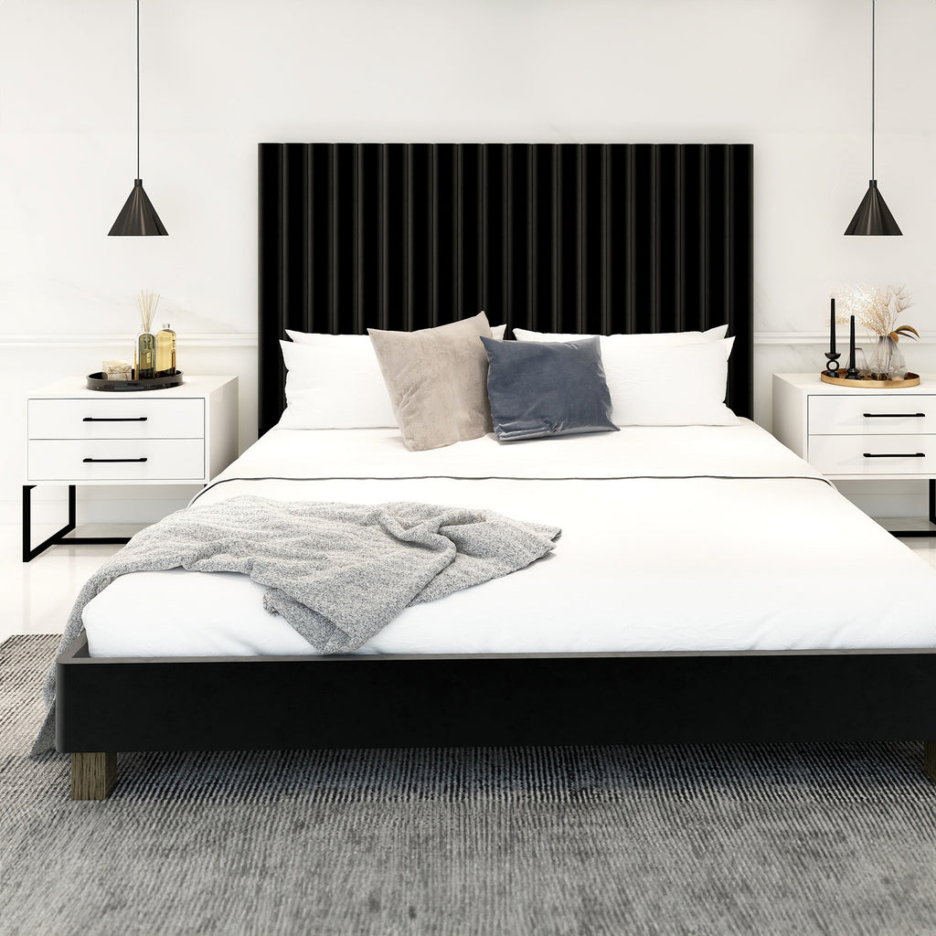 Bedroom with a black headboard and white bedding